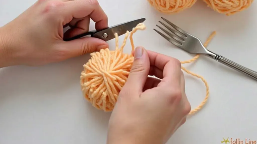 Cutting loops of yarn from a bundle to make a pom-pom